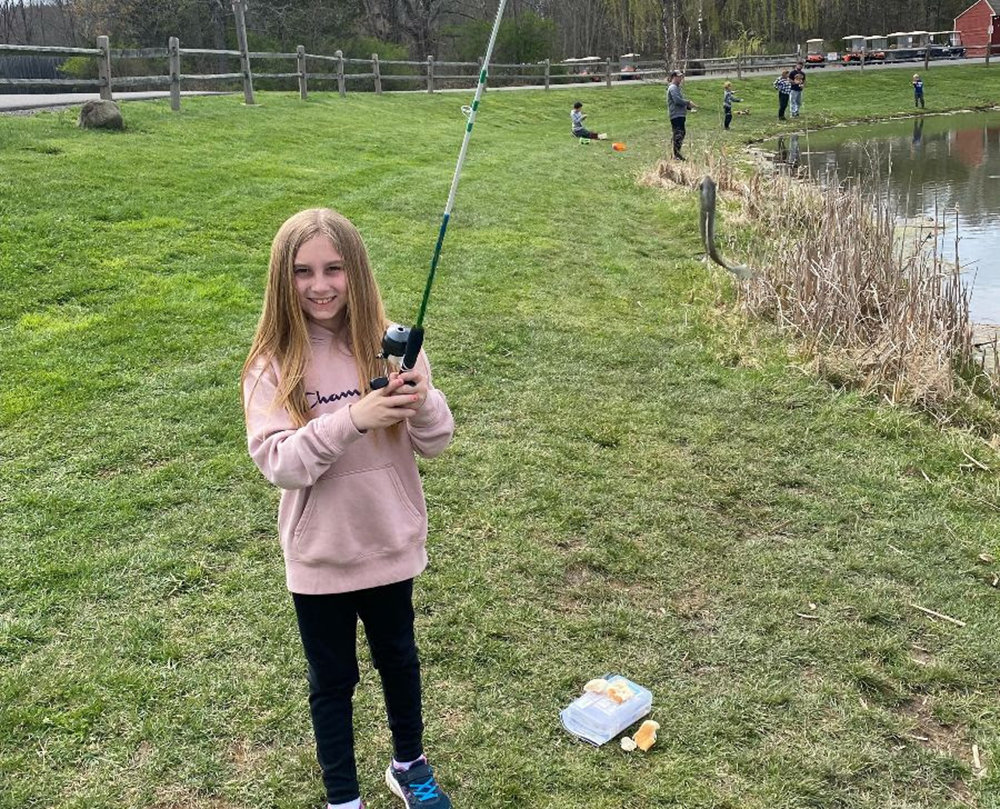 A smiling library patron enjoys a fun day of fishing! Come check out a fishing pole from the Library of Things and have your own fun day or join the Youth Fishing Tournament on Saturday, May 14 from 8 a.m. - 12 noon at 53 Reservoir Road in Highland.